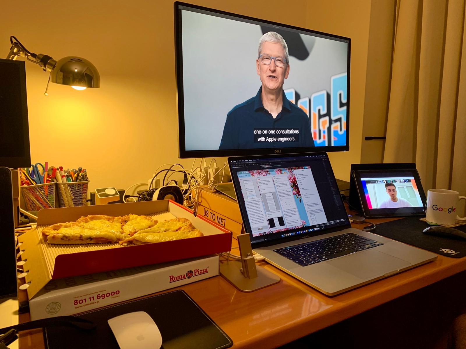 Fran's desk during his nightly iOS study sessions: WWDC on the laptop, notes and pizza